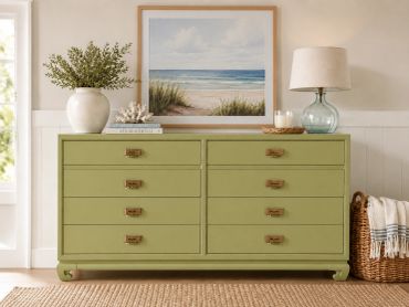 Green dresser with sea-themed artwork and decor.