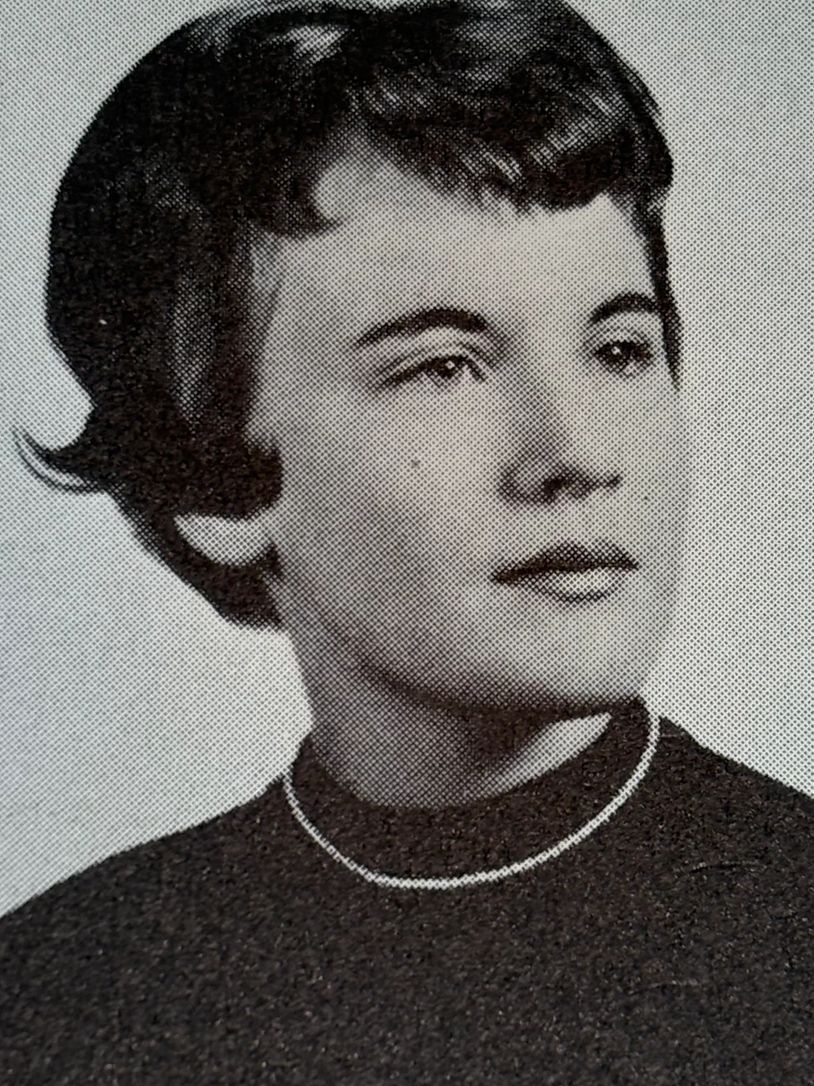 Black and white portrait of a woman with short hair and a necklace.