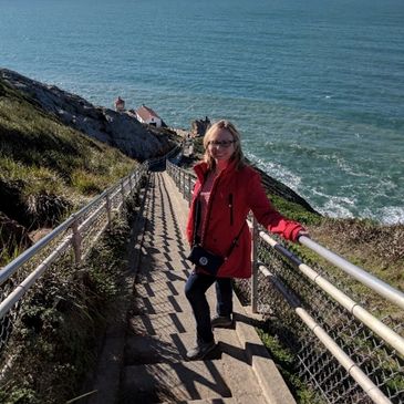 Healthy woman climbing stairs by the ocean.