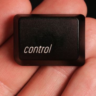 Hand holding Control Keyboard key