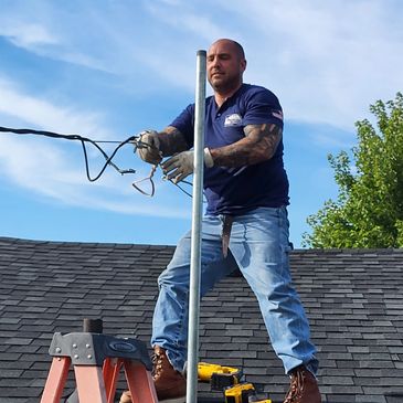 Electricians installing a new Riser and grounding on a home in Redford MI