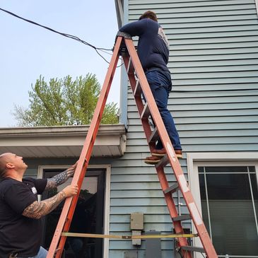 Electricians installing a Riser on a home in Taylor, MI