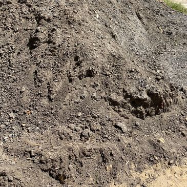 Pile of loose gravel and dirt on the ground.