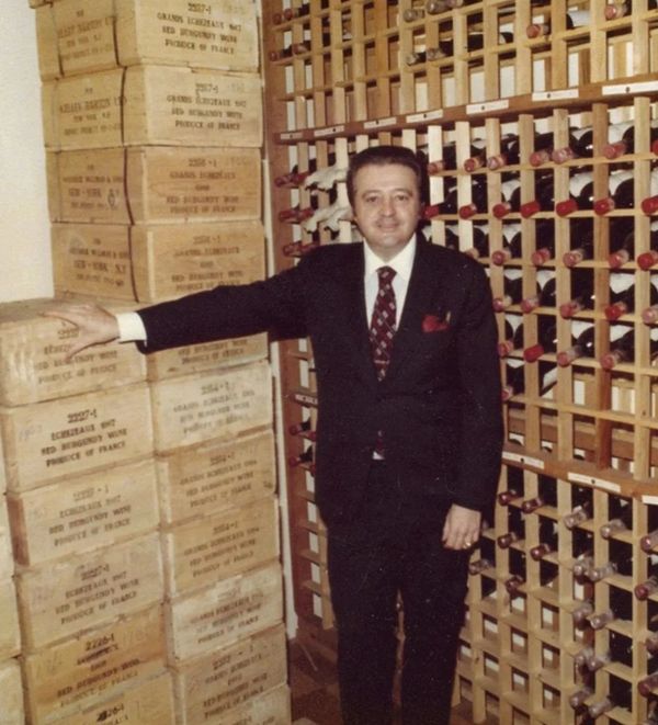 Mario Tucci proudly standing in his wine celler. Mario had the largest collection of wine in the USA