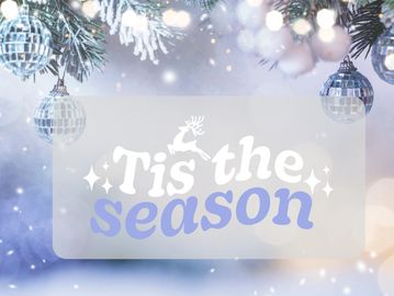 'Tis the season greeting with festive ornaments on a snowy tree.
