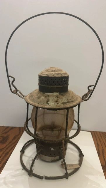 Old rusty lantern covered in dust.