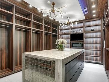 Warmth and elegance was the intention with this expansive walk in closet Unlimited Design-Consulting