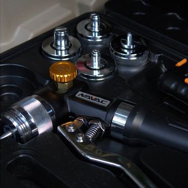 Close-up of a NAVAC branded tool with metallic components in a black case.