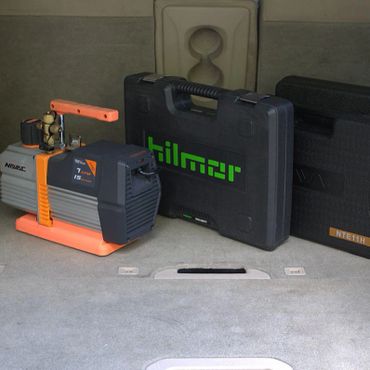 Three industrial tool cases and equipment placed on a gray surface.