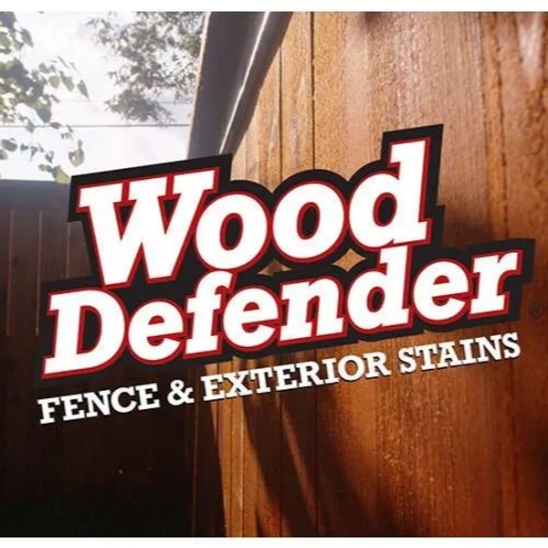 Wood Defender logo on a stained wooden fence.