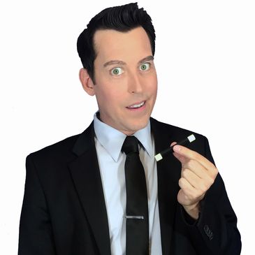 Man in a black suit holding a magic wand, labeled Mike Williams.