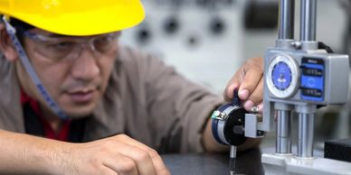 Engineer using precision measuring instrument.