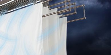 White curtains hanging against a dark sky.