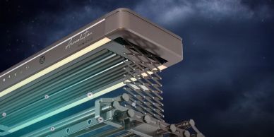 Close-up of a mechanical scissor arm device at night.
