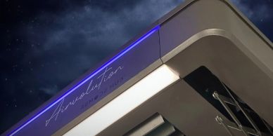 Elegant building corner with neon lights and starry night sky.