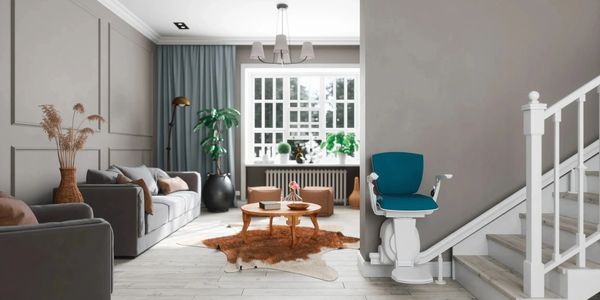 Modern living room with gray sofas, wooden coffee table, and a blue stairlift.
