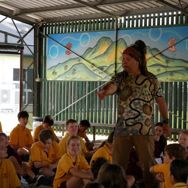 An instructor engages schoolchildren in a colorful outdoor classroom.
