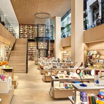 Modern bookstore interior with wooden design and shelves.