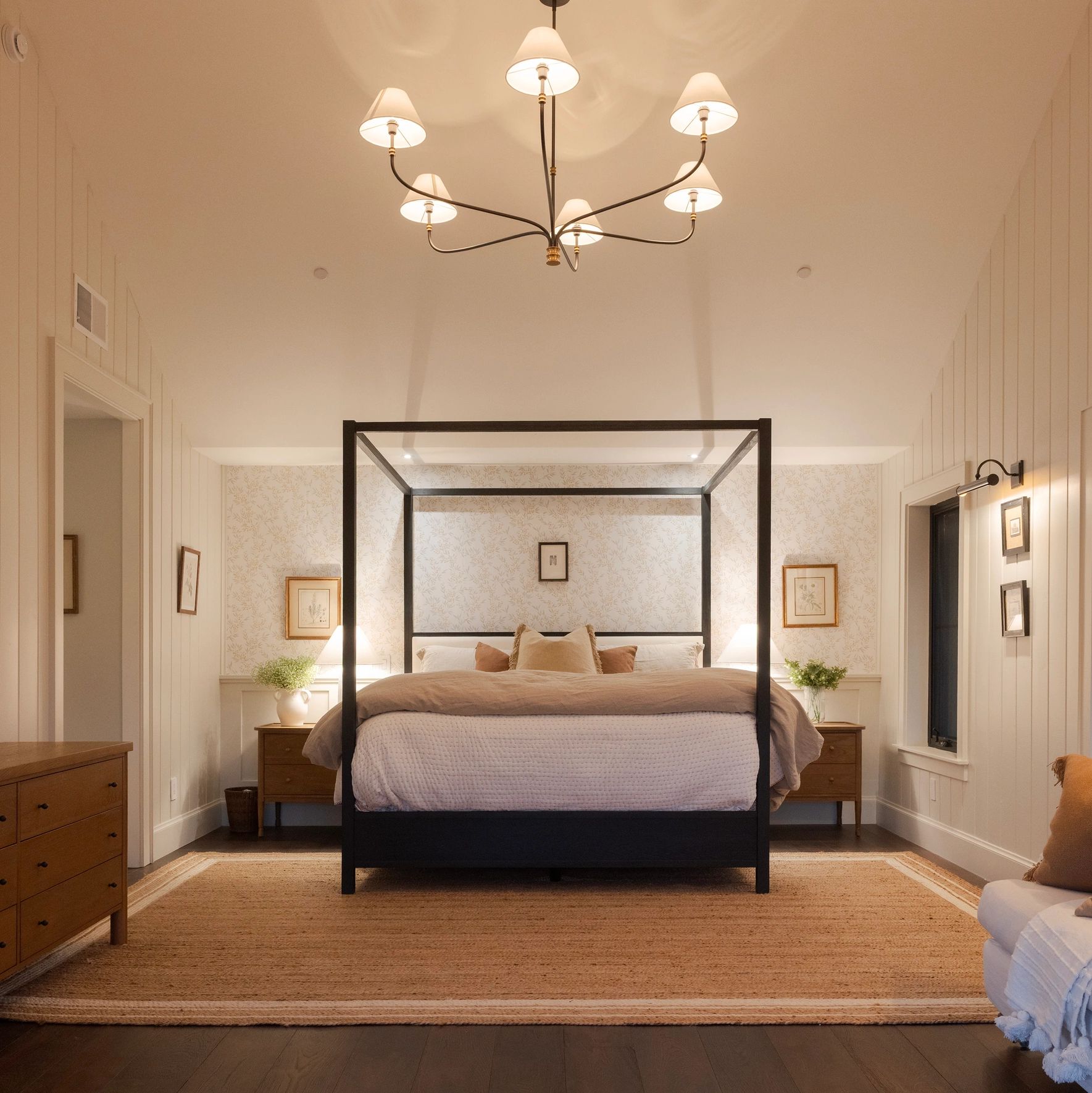 Cozy bedroom with four-poster bed and warm lighting.