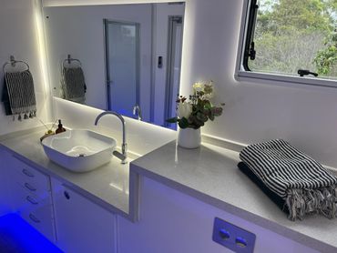 Inside our beautifully presented unit, the vanity offers stone top benches with plenty of storage.