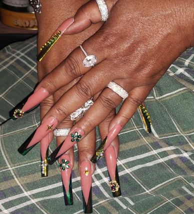 Hands with long nails and multiple silver rings 