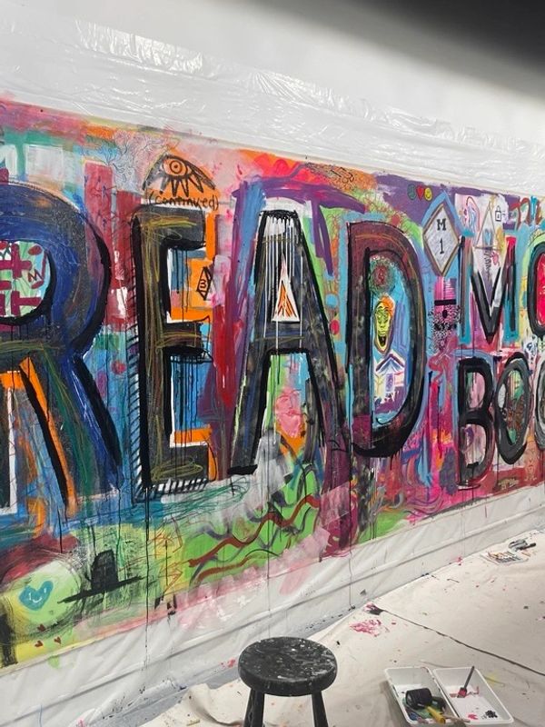 Colorful graffiti spelling "READ" on a wall.