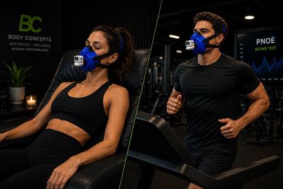 Two people exercising with breathing masks in a gym.