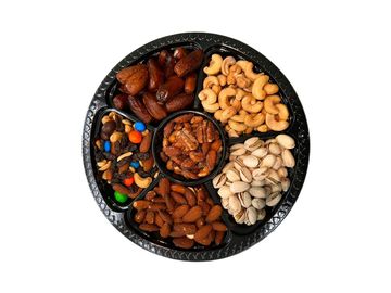 Premium Middle Eastern snack tray with dates, nuts, pistachios and cashews, perfect for sharing.