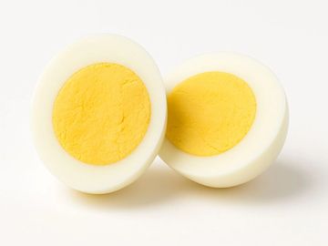 Perfectly boiled egg, halved to reveal a rich yellow yolk – a classic protein-packed snack