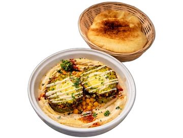 Authentic Israeli falafel on hummus with tahini, parsley, and paprika at The Green Falafel.