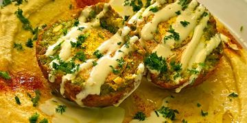 Authentic Israeli falafel on hummus with tahini, parsley, and paprika at The Green Falafel.