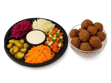 Falafel party platter with fresh salads, pickles, tahini sauce, and 18 crispy falafel – and tasty.