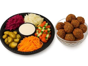 Falafel party platter with fresh salads, pickles, tahini sauce, and 18 crispy falafel – and tasty.