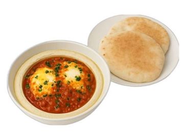 Rich tomato shakshuka with poached eggs over creamy hummus, served with warm, fluffy pocket pita.