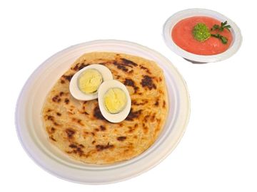 Fresh malawach topped with boiled egg, served with tomato dip and zhug. Authentic Israeli flavor.