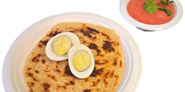 Authentic Yemeni mellawah with egg, fresh sechug and tomato. A warm, flaky Middle Eastern classic.