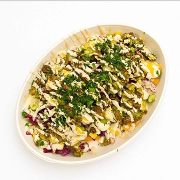 Golden fries loaded with crushed falafel, fresh veggies and tahini for a bold Mediterranean bite.