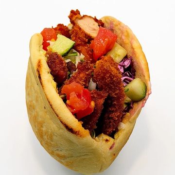 Crispy chicken schnitzel in a warm pocket pita with fresh veggies & bold Mediterranean flavor.