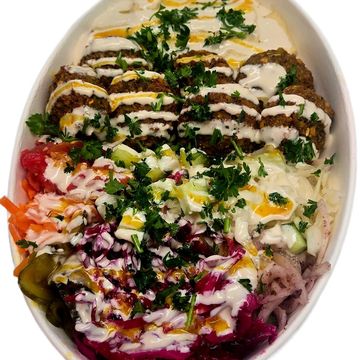 Crispy falafel bowl with fresh veggies and tahini. A flavour packed Mediterranean plant based.