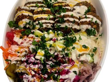 Falafel bowl combo with fresh veggies, fries and drink. A flavour filled Mediterranean based meal.