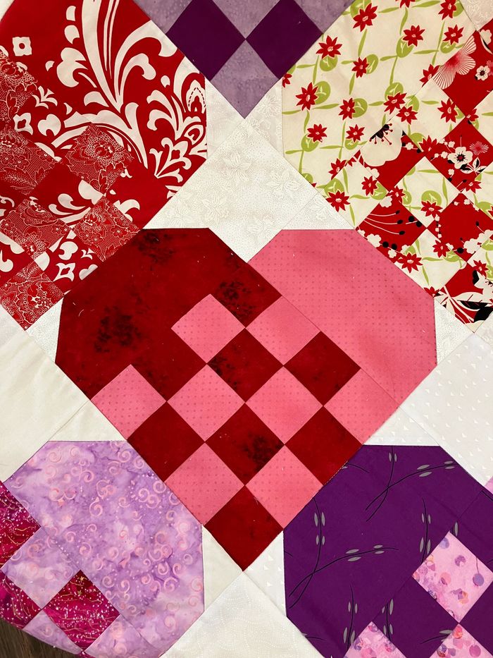 Quilted heart quilt in red/pink/and white
