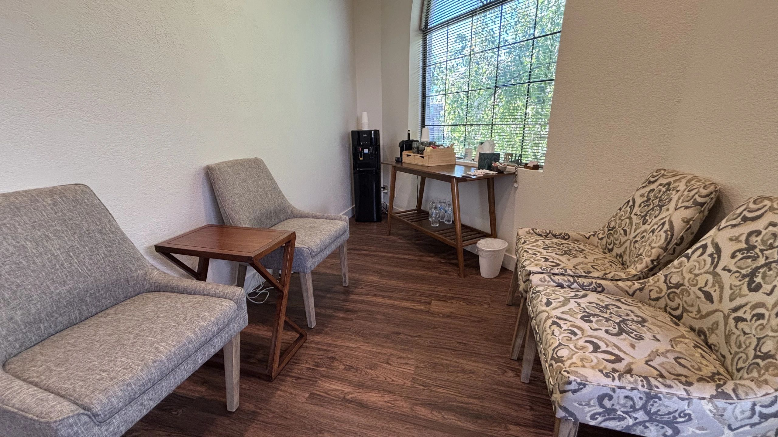 Cozy waiting area with coffee, tea, and water available for clients.