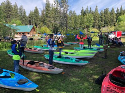 People learning how to kayak with one of our instructors giving kayak lessons