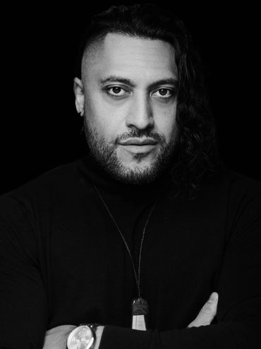 Black and white portrait of a man with a confident look.