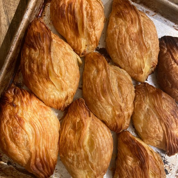 Golden baked pastries arranged on a baking tray.