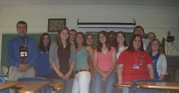 A group of young people posing together indoors.
