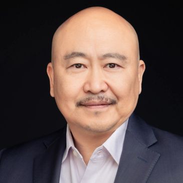 Portrait of a bald man in a suit.