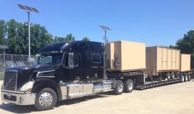 RGN trailer loaded with military freight