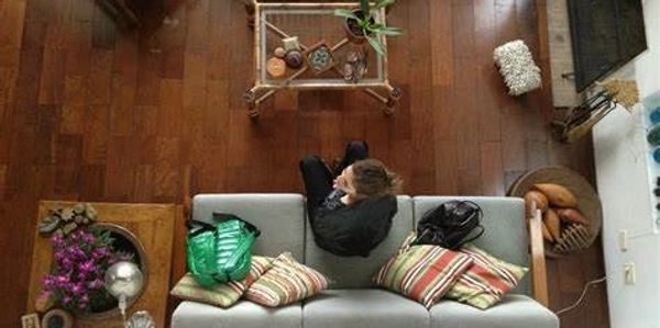 Nielsen Concierge sitting on the couch in a house they are house montioring