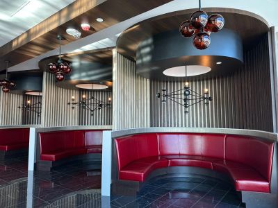 Retro diner booth seating with red cushions.